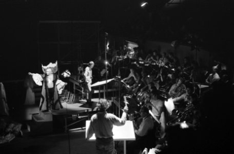 Enkele toneelspelers op een deel van de speelvloer en twee dirigenten bij de ork, Bestanddeelnr 922-5795 photo