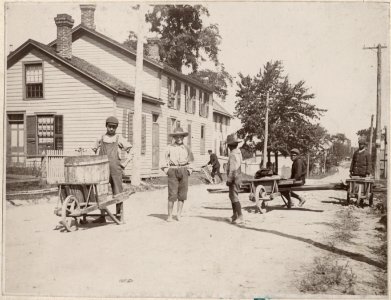 Boys with wheelbarrows in the streets of Amherstburg, Onta…