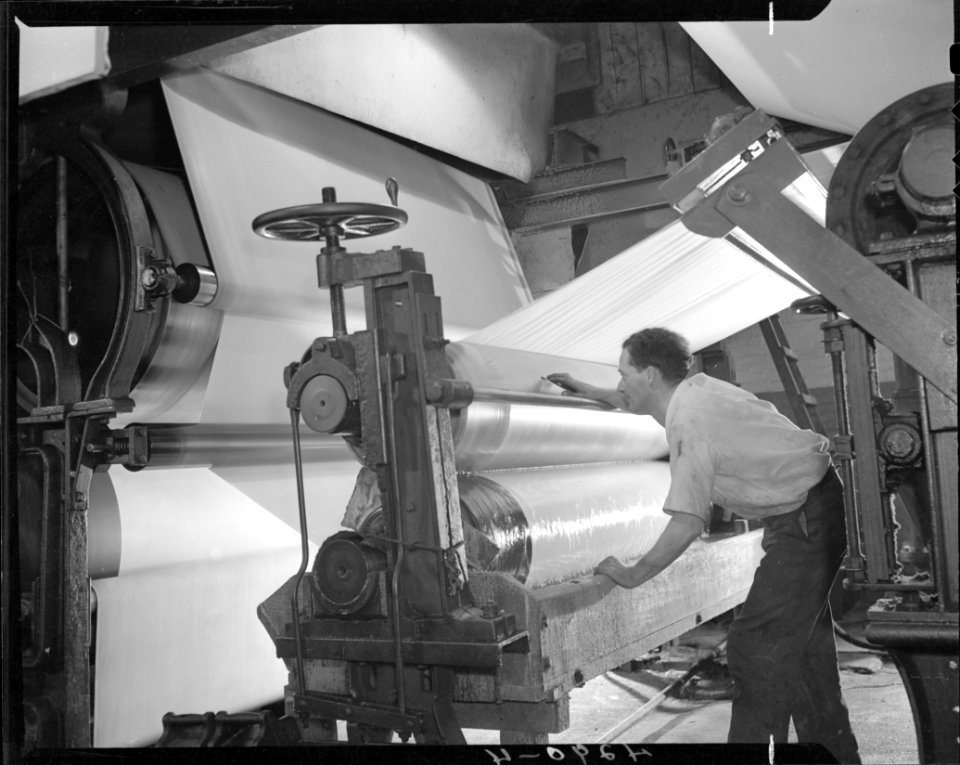 Man working with pulp and paper machinery at Thorold photo