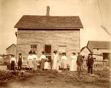 Harris, Hill, and Holland families in front of homestead, … photo