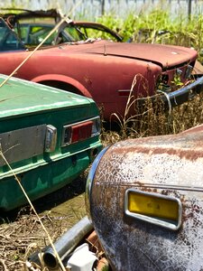 Rusty relics old cars junkyard photo