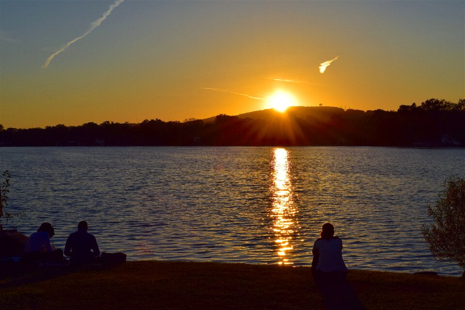 Silhouette sitting water