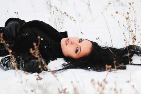 Girl lying snow photo