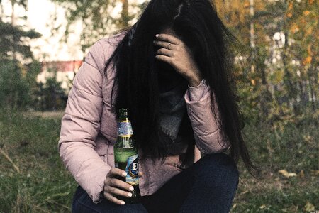 Drunkard on the street with a bottle photo