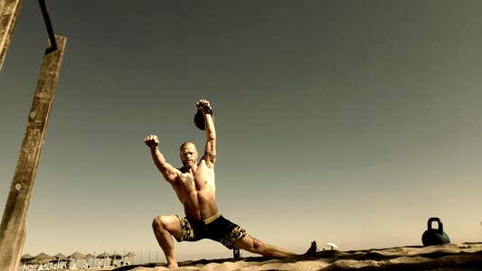Beach no shirt kettlebells