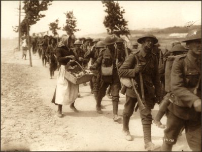 French women selling oranges to Canadian troops on their r…