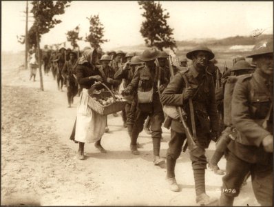 French women selling oranges to Canadian troops on their r… photo