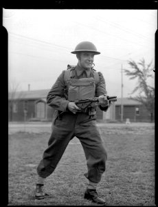 Soldier aiming a Sten Machine Carbine photo