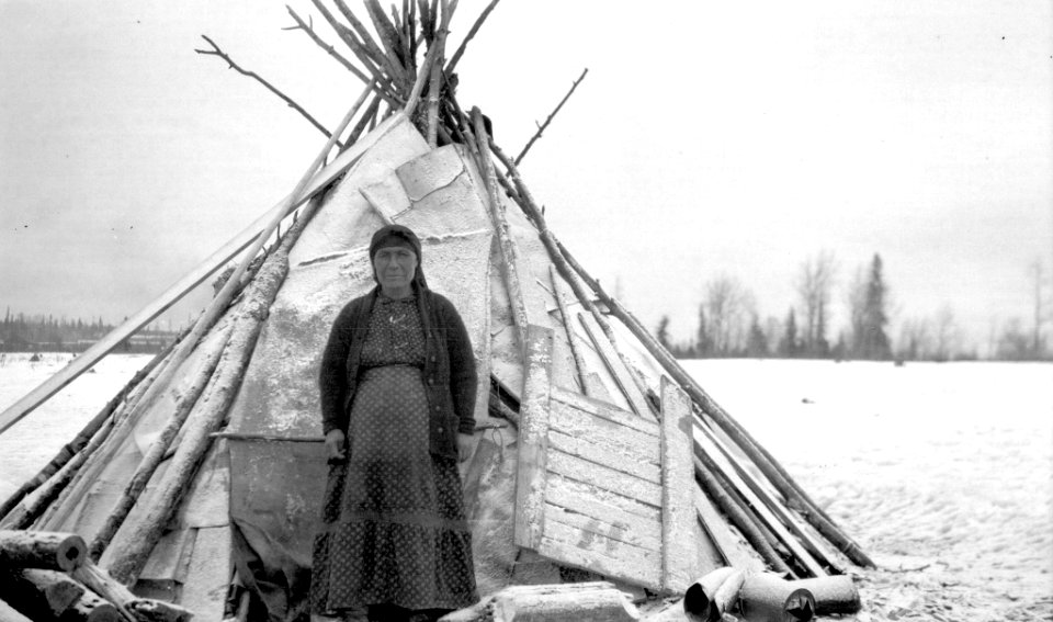[Indigenous woman pictured in front of wigwam] photo