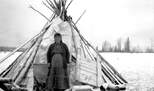 [Indigenous woman pictured in front of wigwam] photo