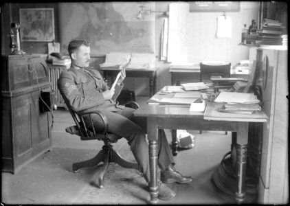 Sergeant at desk reading photo