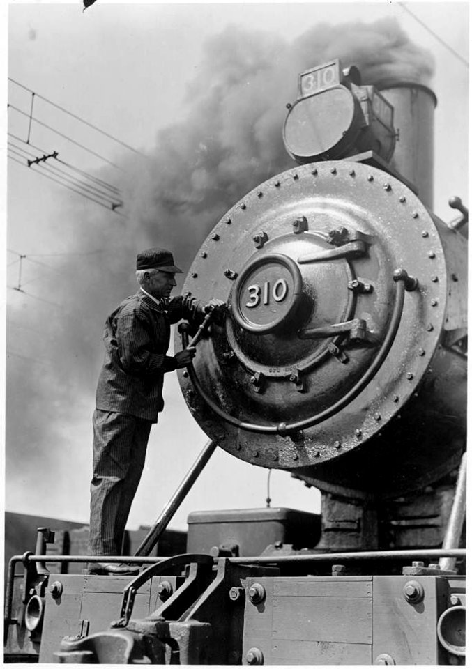 Railway engineer doing repair work to locomotive