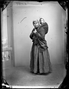 Portrait of a woman with her baby on her back photo