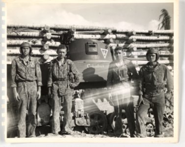 Members of light tank crew pose in front of Jap plane reve…