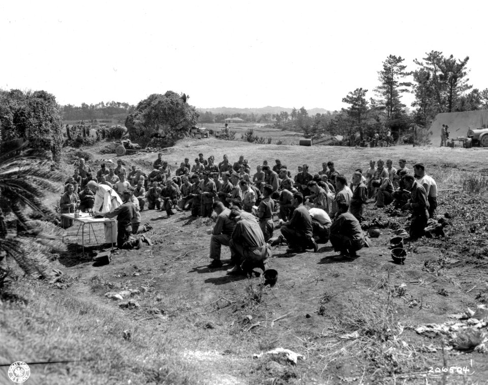SC 206504 - Men of 27th Division kneel in prayer as Chapla… photo