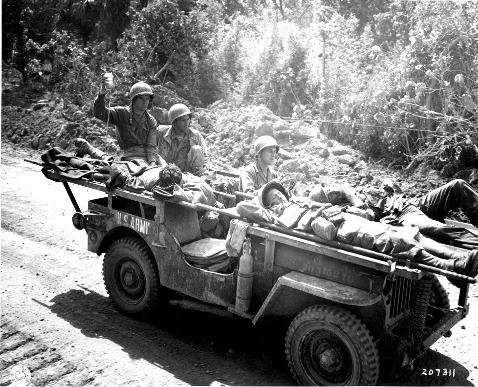 SC 207311 - As an ambulance jeep evacuates three wounded U…