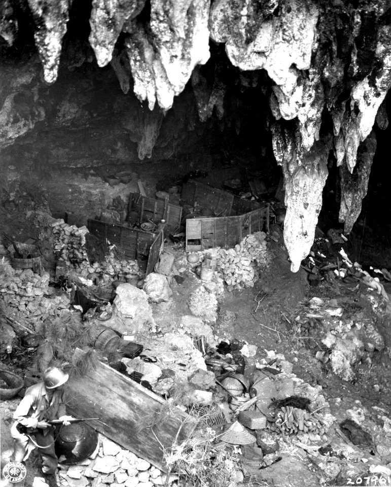 SC 207961 - An American soldier, advancing on a cave recen…