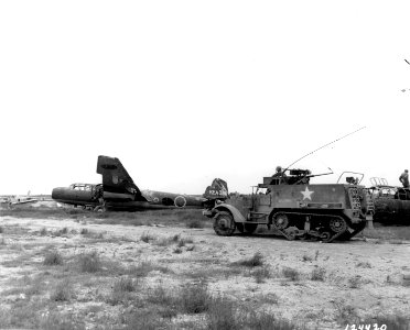 SC 124420 - A soldier in a Yank half track looks at a demo…