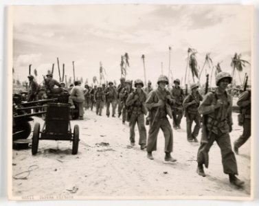 Their job on Tarawa completed, these Marines march toward …