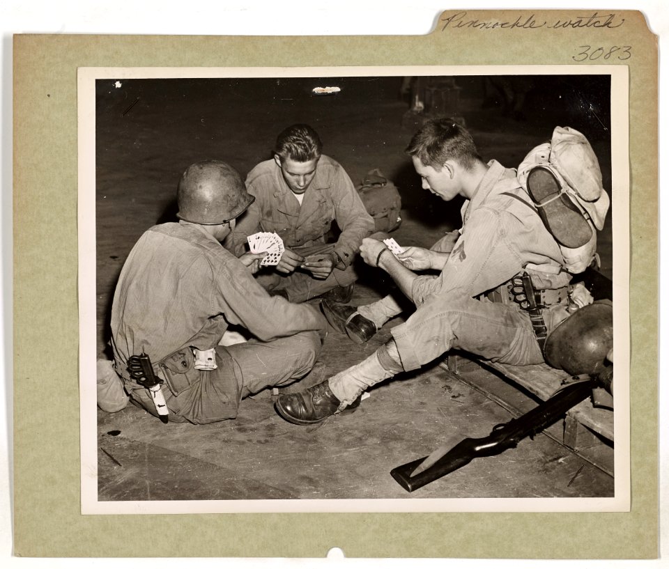 Three soldiers, awaiting to board a combat-bound U.S. Coas…