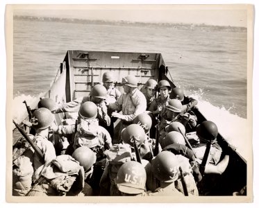 U.S. Coast Guardsmen take a party of Navy men ashore to se…