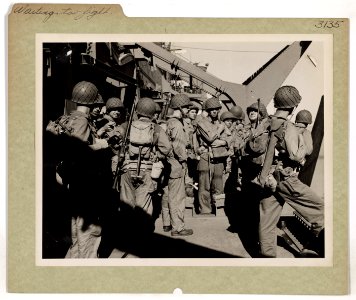 Somewhere in the South Pacific, U.S. troops on the deck of…