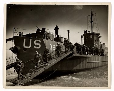 Down the twin ramps of a Coast Guard-manned LCIL, Yankee f…