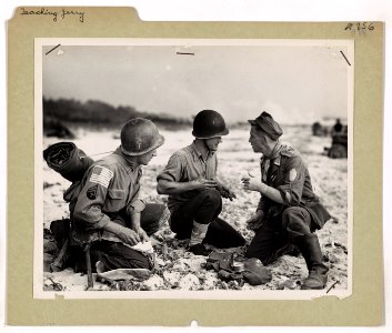 A Coast Guardsman and an Army medic interview a German war…