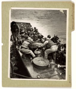 Wounded by Nazi machine gun fires bursting at an LCVP as i…