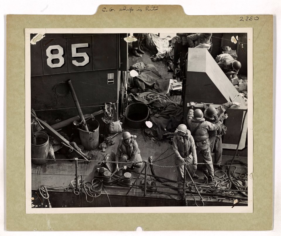 Wounded American fighters lay on stretchers on the deck of…