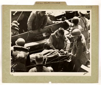 A Coast Guard pharmacist's mate gives first aid to an Amer…