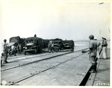 SC 275416 - A Rhino ferry unloads vehicles on to the cause…