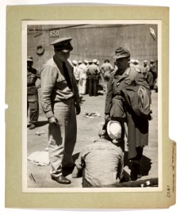 U.S. Coast Guardsmen and German prisoners mingle on a Nort…