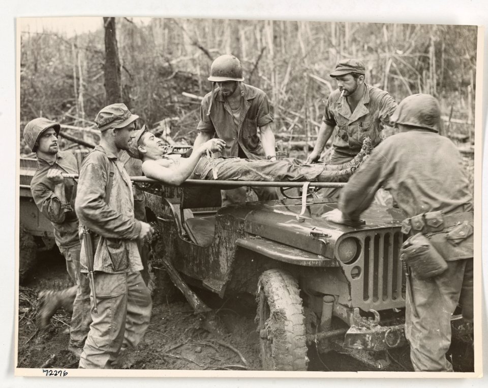 A wounded Marine is lifted onto a jeep converted into an a…