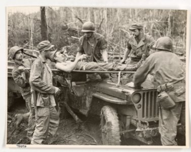 A wounded Marine is lifted onto a jeep converted into an a…