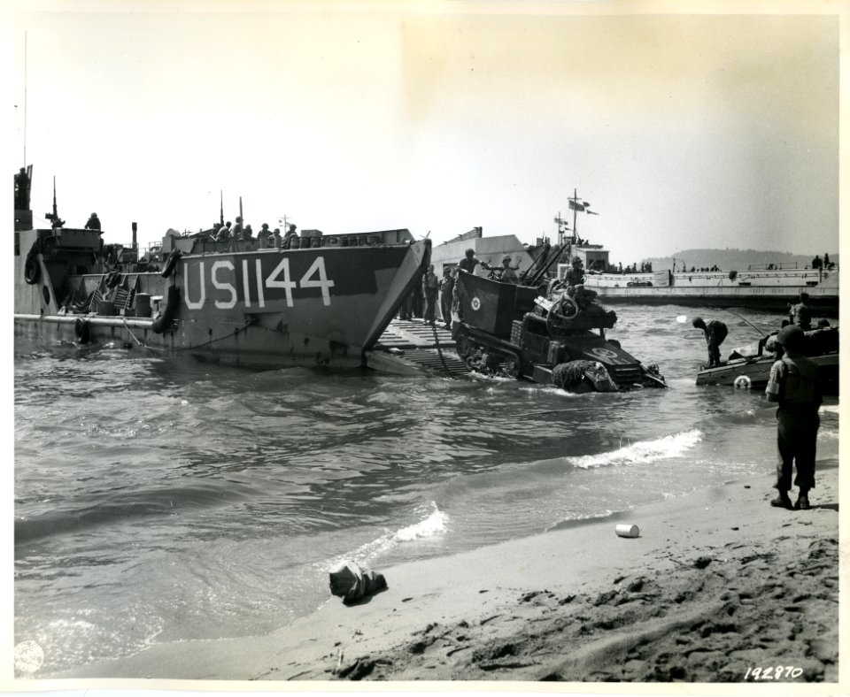 SC 192870 - AAA half-trucks are driven off an LCT, as Amer…