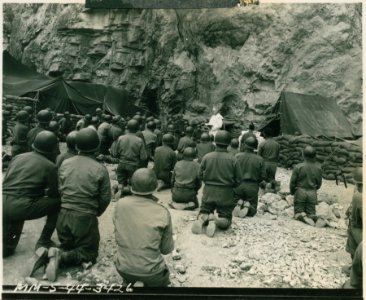 Steel helmeted American soldiers kneel in reverence at Eas… photo