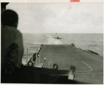 A Navy Grumman F6F Hellcat lands on its carrier following … photo