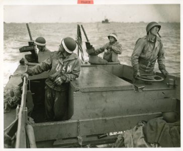 Eyes Alert! Navy men aboard a landing craft keep a sharp l…