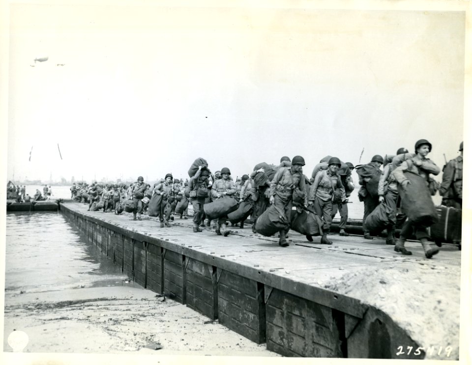 SC 275419 - At hightide troops debark from LCT on to cause…