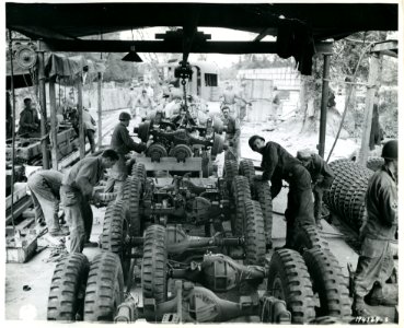 SC 194139-S - GIs and French civilians work on a vehicle a…