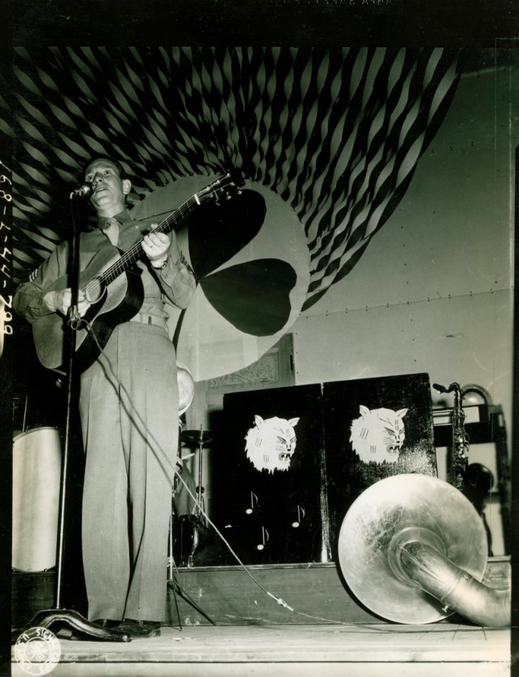 S/Sgt Lloyd Perryman playing guitar 36th Spec Serv Co part…