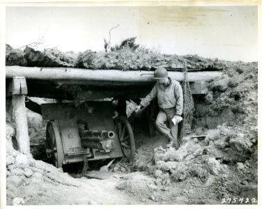 SC 275422 - An American soldier points to a 75-mm German g…