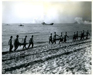 SC 192868 - The wounded are carried back to the beach to b…