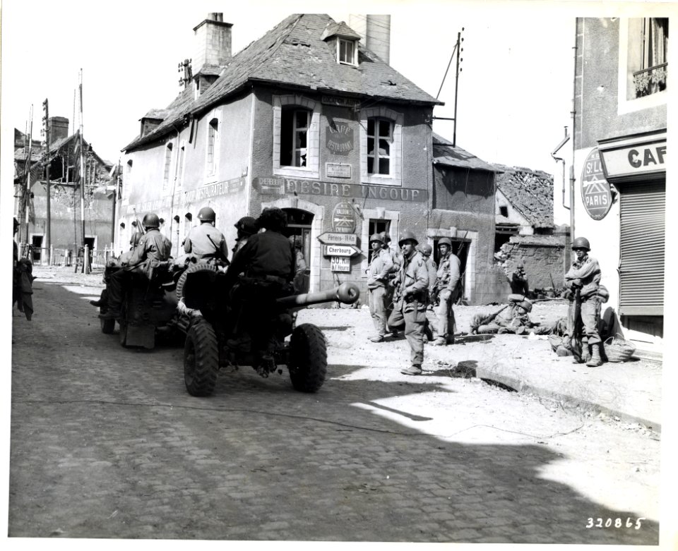SC 320865 - Troops in a jeep tow light artillery through a…