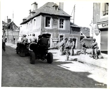 SC 320865 - Troops in a jeep tow light artillery through a…