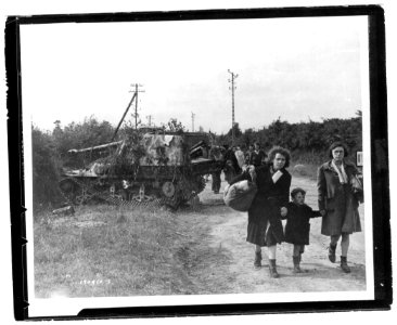 SC 190510 - French refugees file past a wrecked German tan…