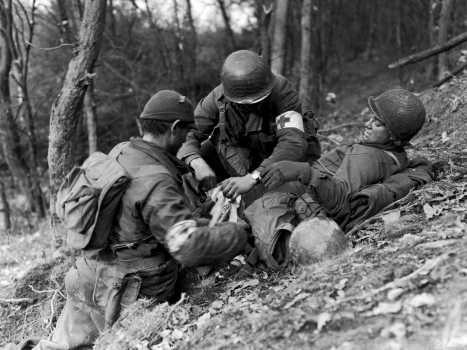PFC Benny Barrow, of St. Louis, Missouri, is aided by medi…