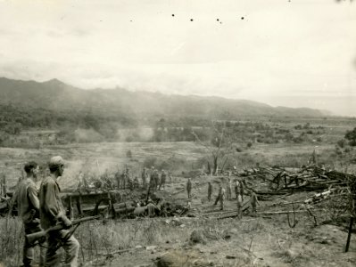 SC 200772 - American soldiers investigate a Japanese 12-in…