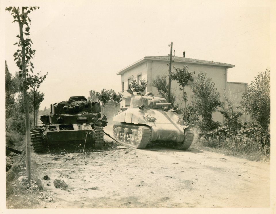 American tank passes knocked-out Mark IV on the road near …